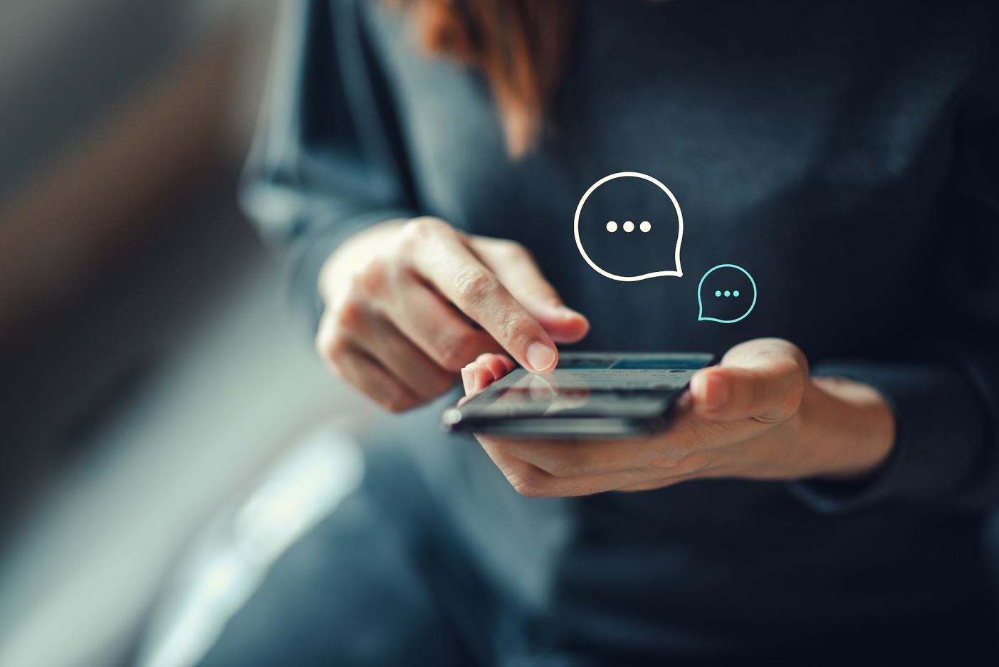 Woman holding smartphone with speech bubbles indicating use of community communication tools